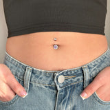 Silver navel piercing with purple crystal