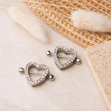 Silver heart nipple piercings with white crystals